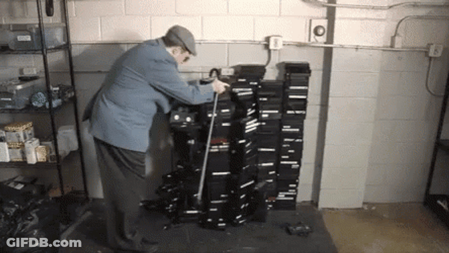 Funny Man Falling On Stack Of Vhs GIF
