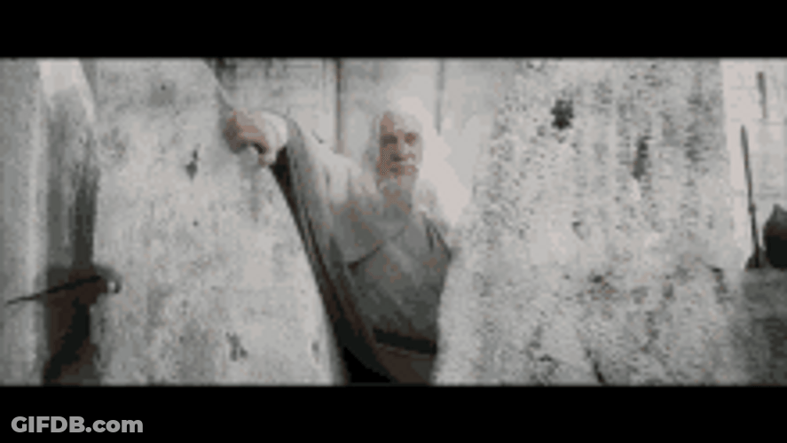 Gandalf Looking Behind The Rock GIF