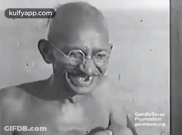 Gandhi Smiling In Black And White With Glasses GIF