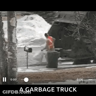 Garbage Truck Driving Down Street Next To Mailbox And Trash Can GIF
