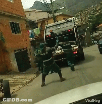 Garbage Truck With Prefeitura On Back Driving Down Street GIF