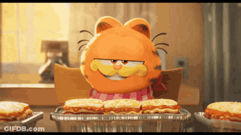 Garfield Sits At A Table With A Tray Of Food GIF