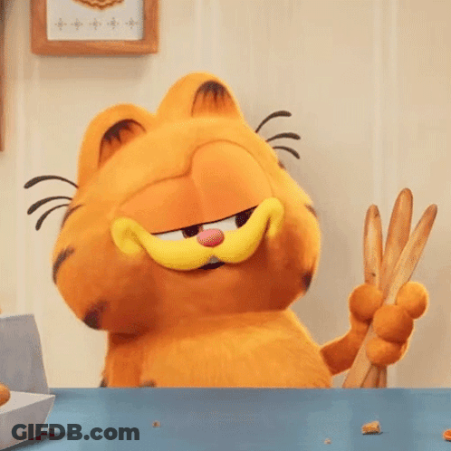 Garfield The Cat Is Sitting At A Table Holding A Pair Of Tongs . GIF