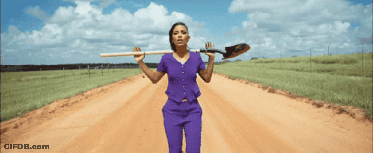 Gaunt Lady Singing While Holding Shovel GIF