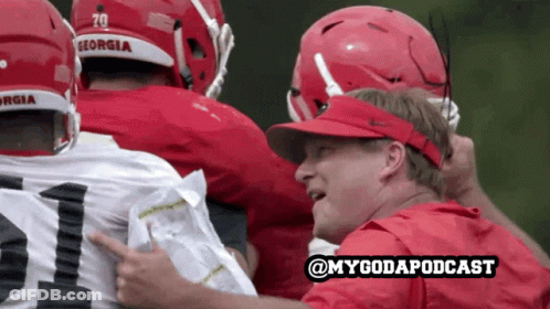 Georgia Football Huddle With Man In Red Shirt Pointing GIF