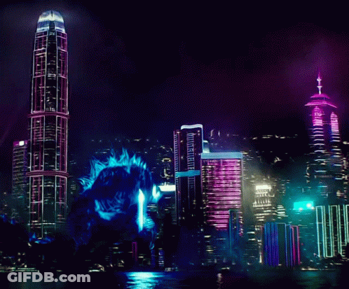Giant Monster Standing Before City Skyline At Night GIF