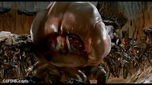 Giant Monster With Huge Mouth Surrounded By Smaller Monsters GIF