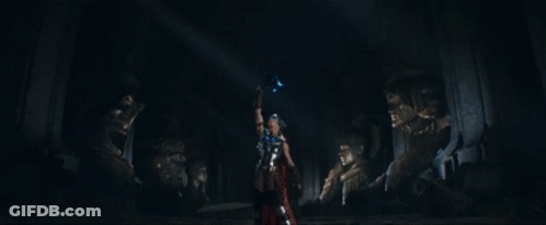 Giant Robot Standing In Front Of City With Sun Shining Through Clouds GIF