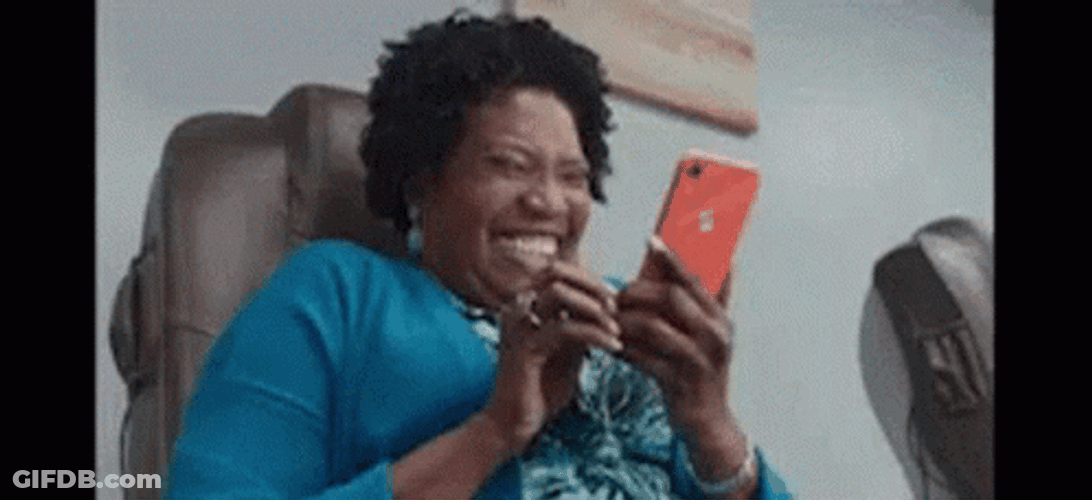 Giggling Woman At Phone GIF