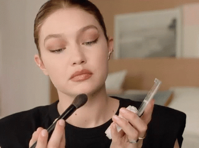 Gigi Hadid Blowing Her Makeup Brush GIF