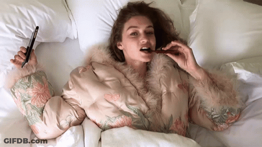 Gigi Hadid Eating While Lying Down GIF