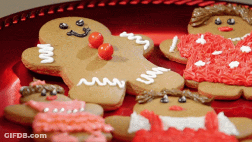 Gingerbread Cookies On A Red Plate With One That Says ' I 'M A Gingerbread Man ' On It GIF