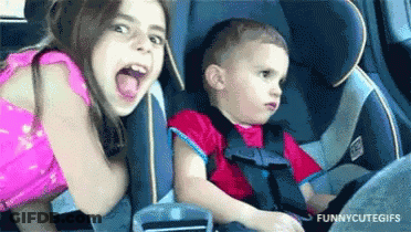 Girl And Boy Sitting In Car Seat GIF