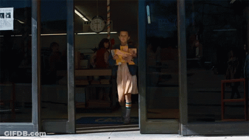 Girl Carrying Stack Of Books In Front Of Turkey Store 8 Cents GIF