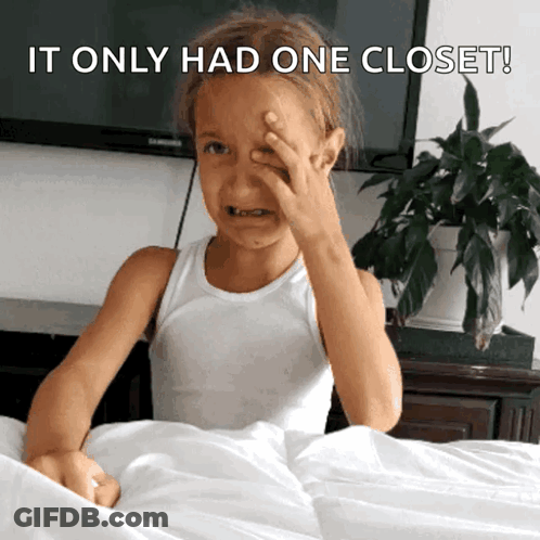 Girl Covering Face Behind Closet GIF