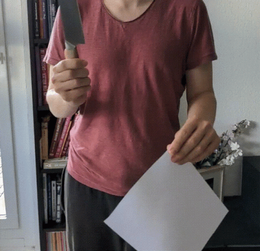 Girl Cutting Paper Using Sharp Knife GIF