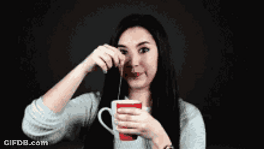 Girl Dipping Tea Bag And Looking Around GIF