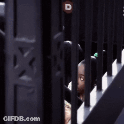 Girl Eating Pizza Behind Bars GIF
