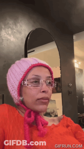 Girl Giving Thumbs Up In Front Of Blackboard Saying EV GIF