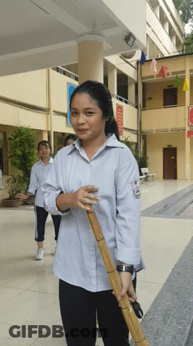 Girl Holding Broom With A Sign GIF
