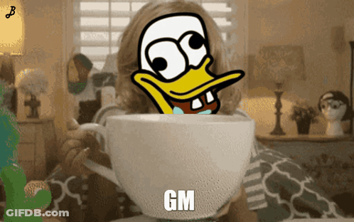 Girl Holding Cup With Duck Saying GM GIF
