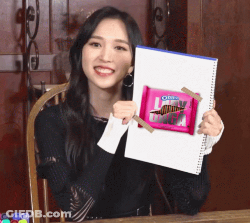 Girl Holding Pink Oreo Bar GIF