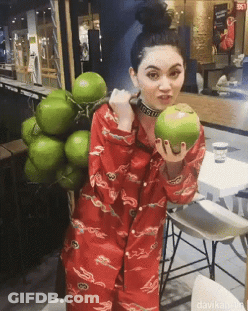 Girl Holding Plenty Of Coconut Tree GIF