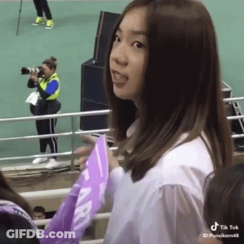 Girl Holding Purple Flag Sticking Tongue Out GIF
