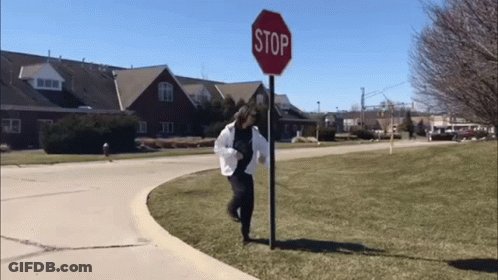Girl Holding Stop Sign GIF