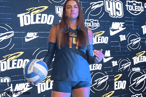 Girl Holding Volleyball In Front Of Toledo Wall GIF