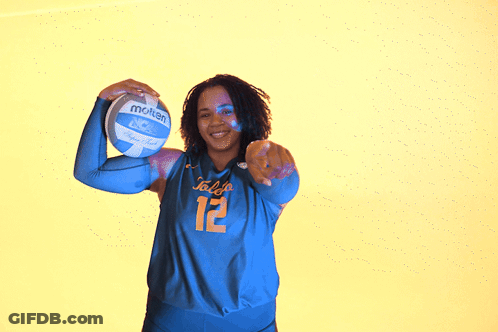 Girl Holding Volleyball In Front Of Toledo Wall GIF