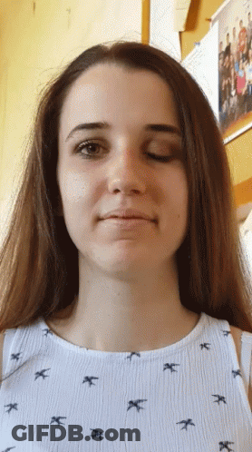 Girl In Bird Shirt Looking At Camera GIF