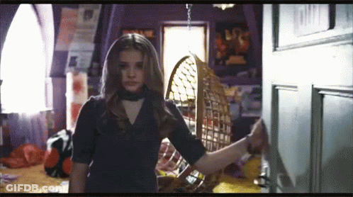 Girl In Black Dress Standing In Room GIF