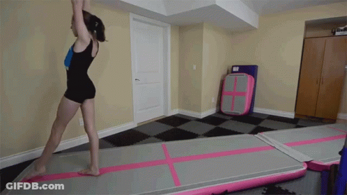 Girl In Black Leotard Doing Trick GIF