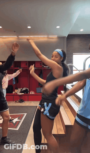 Girl In Black Tank Top And Blue Shorts Dancing In Locker Room GIF