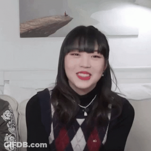 Girl In Black Turtleneck And Plaid Sweater Smiling GIF