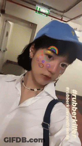 Girl In Blue Hat White Shirt With Rainbow On Face GIF