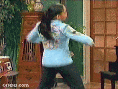 Girl In Blue Jacket Dancing In Front Of Piano GIF