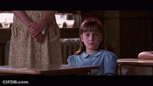 Girl In Blue Shirt At Desk GIF