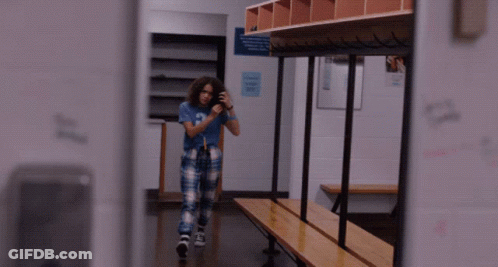 Girl In Blue Shirt Letter A Looks In Mirror GIF