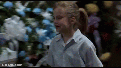 Girl In Blue Shirt With Christmas Tree GIF