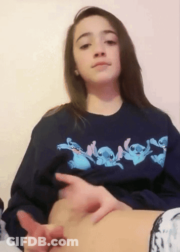 Girl In Blue Stitch Sweatshirt Touching Belly GIF