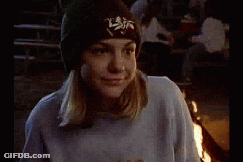 Girl In Blue Sweatshirt And Black Hat Sitting Next To Man GIF