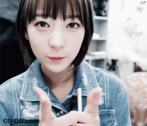 Girl In Denim Jacket Holding Lollipop GIF