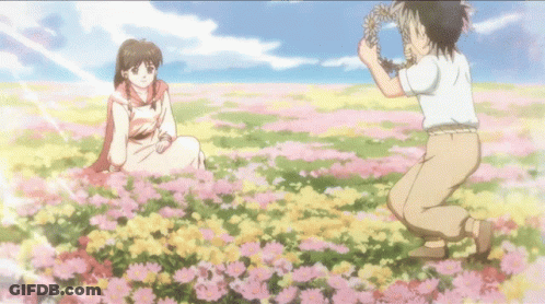 Girl In Flower Field Boy Holding Wreath GIF