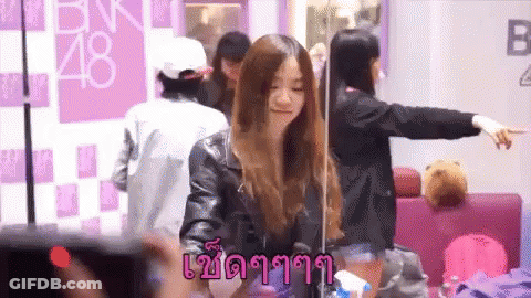 Girl In Front Of BNK48 Sign GIF