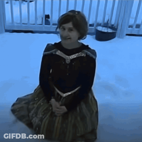 Girl In Frozen Costume Kneeling In Snow GIF