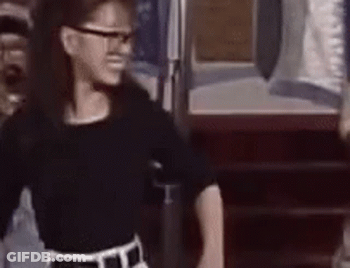 Girl In Glasses And Black Shirt At Door GIF