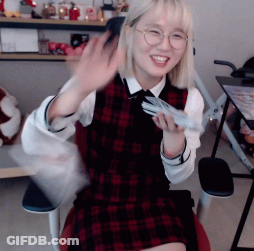 Girl In Glasses And Plaid Vest Sitting GIF