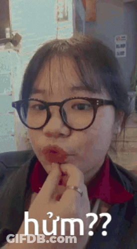 Girl In Glasses And Red Shirt Making Funny Face GIF